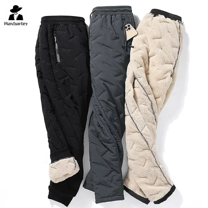 Three pairs of waterproof winter down ski pants in black, gray, and cream laid flat for display.