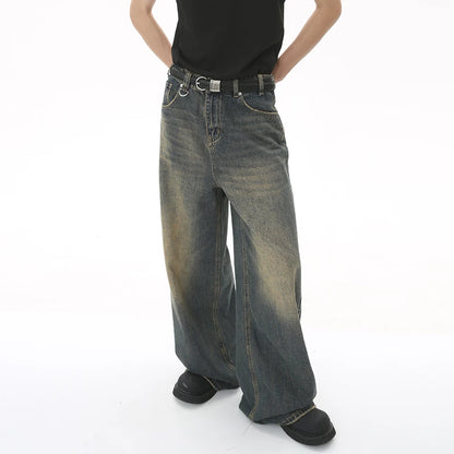 old blue washed denim pants modeled by a person, featuring a wide-leg style and vintage design.