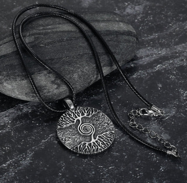 Asgard Celtic Tree Of Life pendant with stainless steel chain displayed on dark stone background.