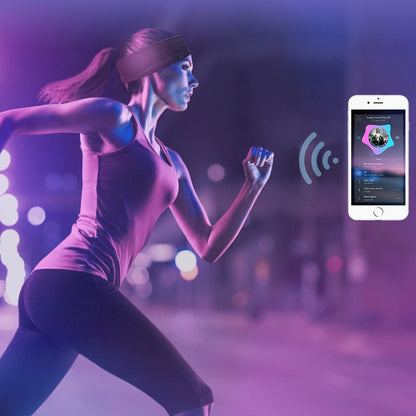 Woman running outdoors wearing a wireless Bluetooth sports headband, connected to a smartphone playing music.