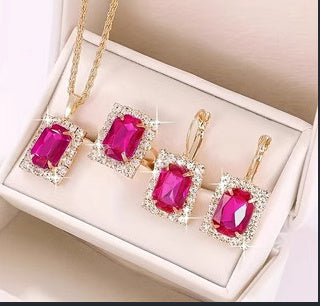 Elegant three-piece jewelry set featuring pink crystal necklace and earrings, beautifully displayed in a gift box.