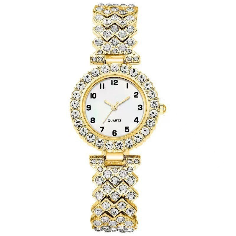 Gold quartz ladies watch with crystal embellishments and a stylish bracelet design for elegant fashion.