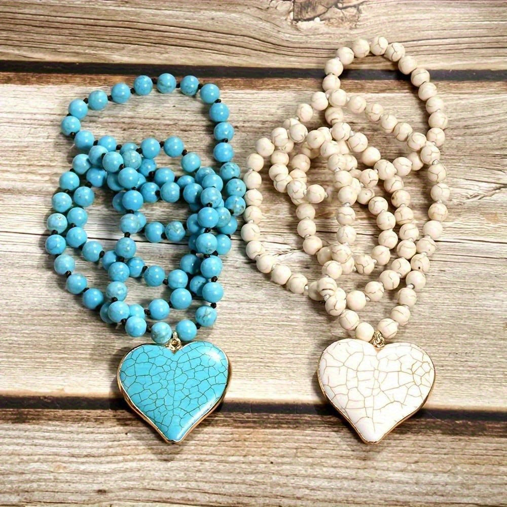 Vintage ethnic style handmade knotted beaded necklace with turquoise and love white heart-shaped pendants.