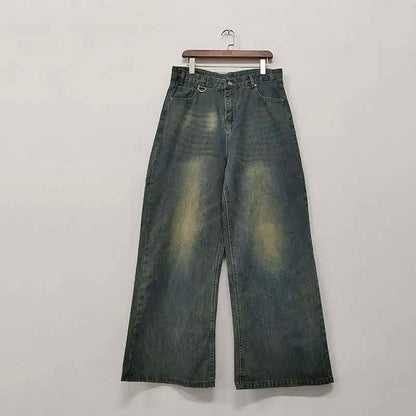 old blue washed denim pants displayed on a hanger showcasing wide leg design and vintage wash.