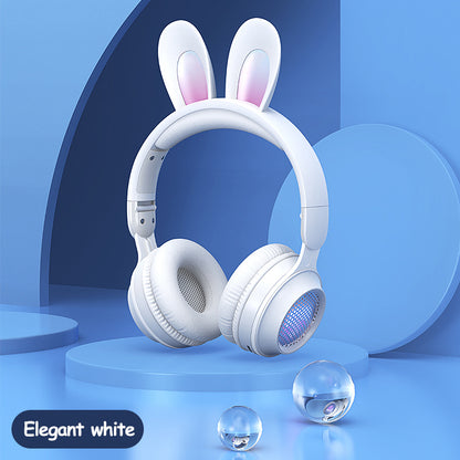 Wireless rabbit ear headphones in elegant white with luminous features, ideal for music and calls, on a blue background.