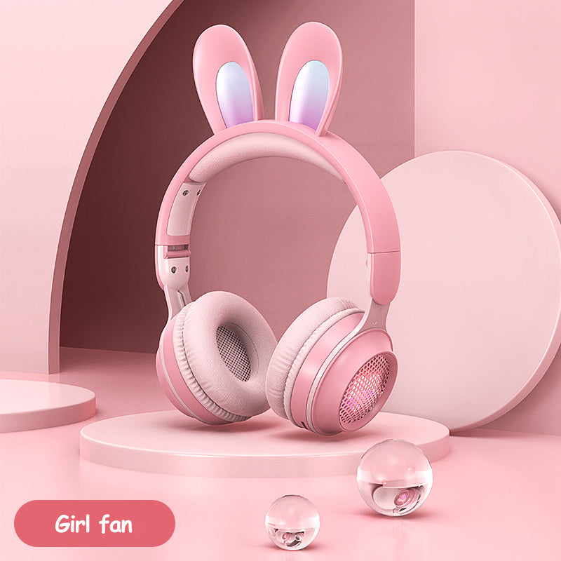 Wireless rabbit ear headphones in pink with luminous ears, designed for girls, on a pastel background.