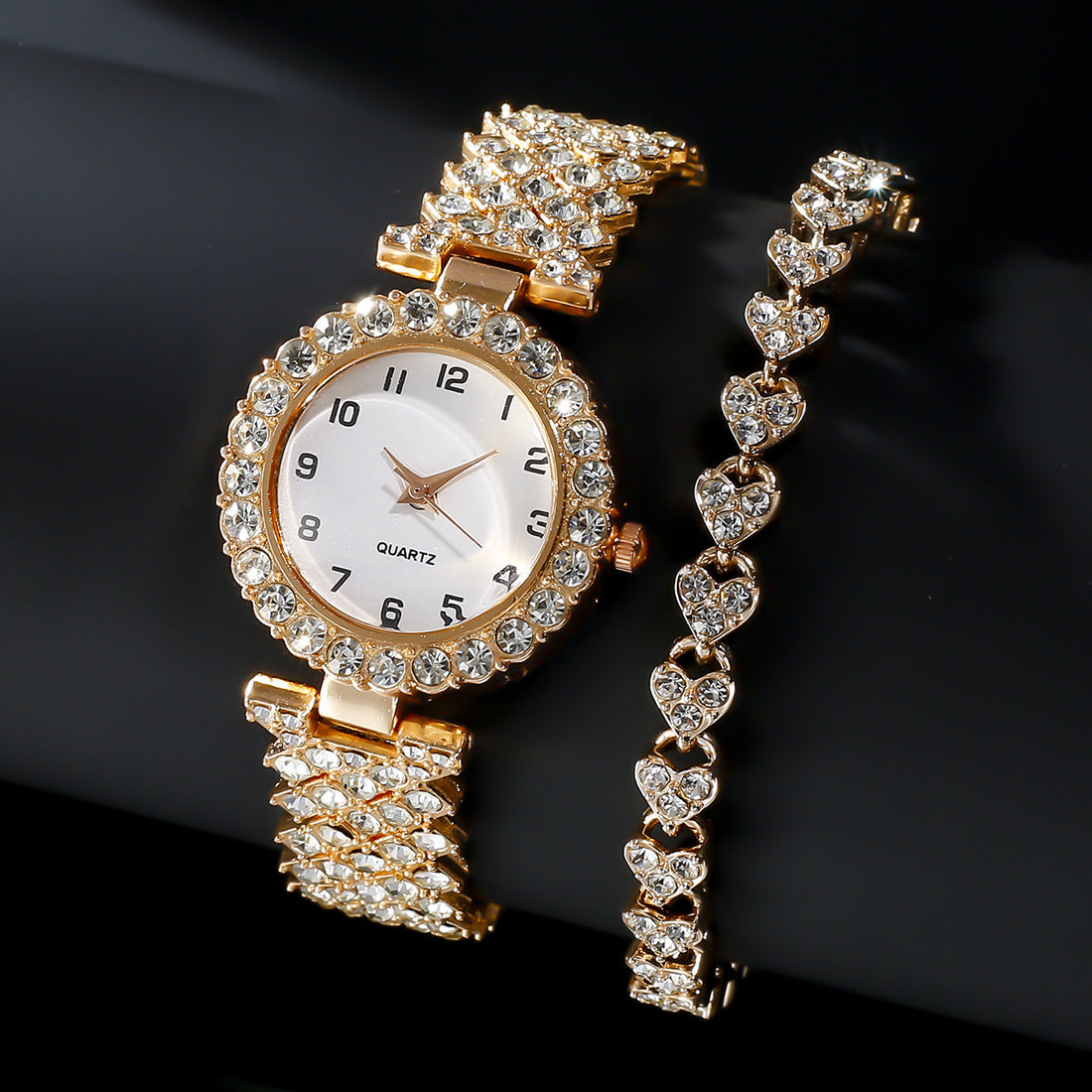 Elegant gold quartz wristwatch with sparkling embellishments and matching heart bracelet for women. Perfect fashion jewelry set.